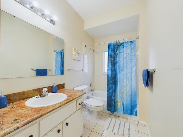 full bathroom with tile patterned floors, vanity, toilet, and shower / bath combo with shower curtain