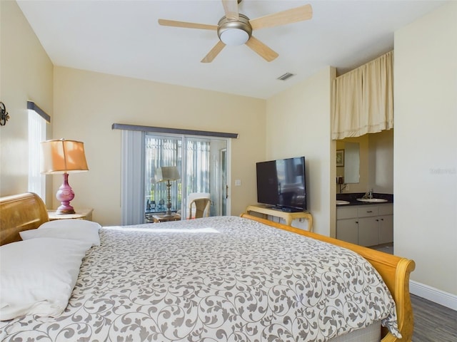 bedroom with dark hardwood / wood-style flooring, access to outside, ceiling fan, and connected bathroom