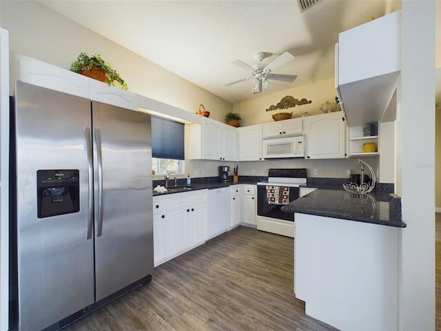 kitchen with white appliances, sink, dark hardwood / wood-style floors, ceiling fan, and white cabinetry