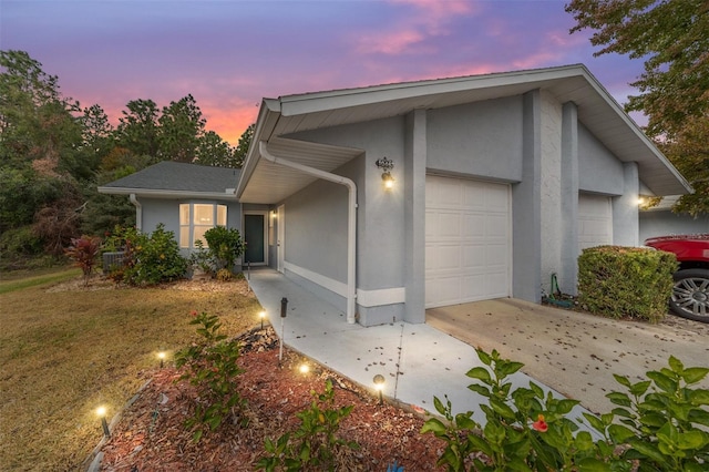 property exterior at dusk with a garage