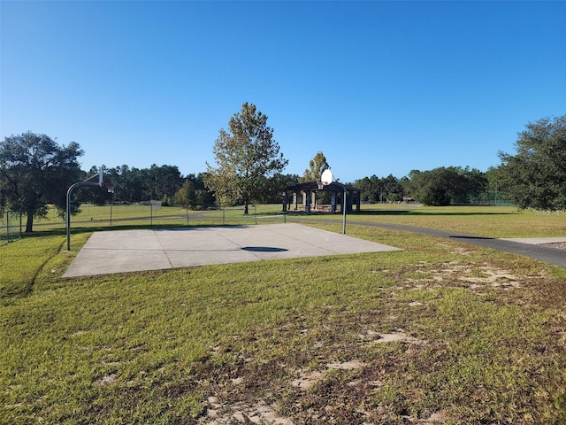 view of sport court featuring a yard