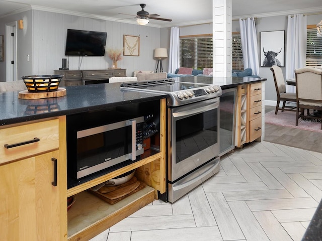 kitchen featuring stainless steel appliances, ornamental molding, and plenty of natural light