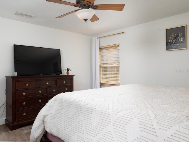 bedroom with light hardwood / wood-style floors and ceiling fan