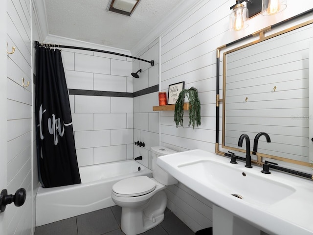 full bathroom featuring sink, tile patterned floors, ornamental molding, and a textured ceiling