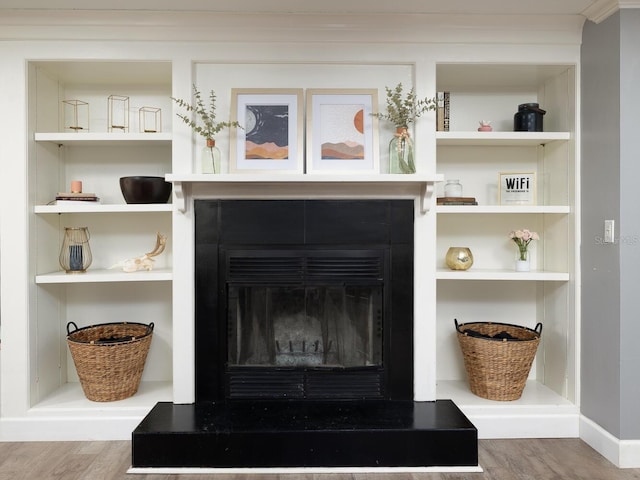 room details featuring built in shelves and wood-type flooring