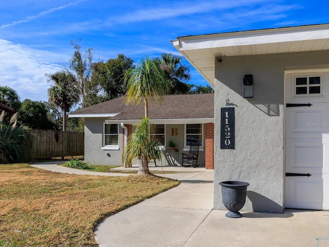 exterior space featuring a lawn and covered porch