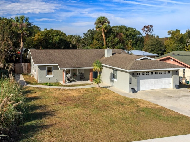 ranch-style house with a garage, a front yard, and covered porch