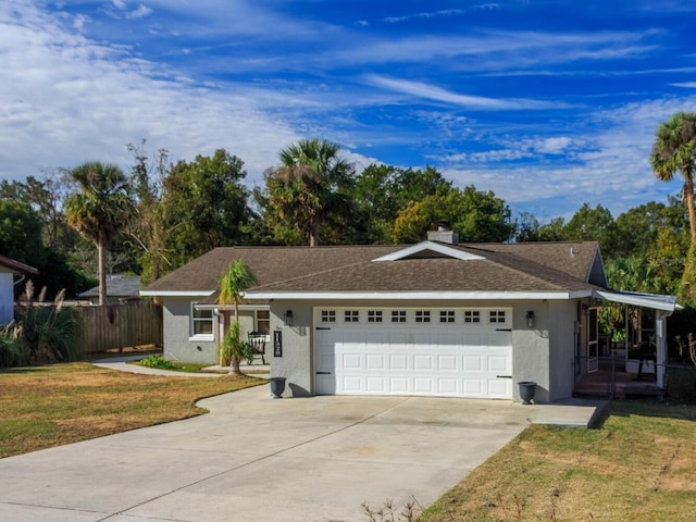 ranch-style house with a garage and a front lawn