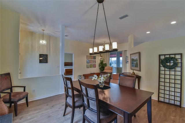 dining space featuring a chandelier and wood-type flooring