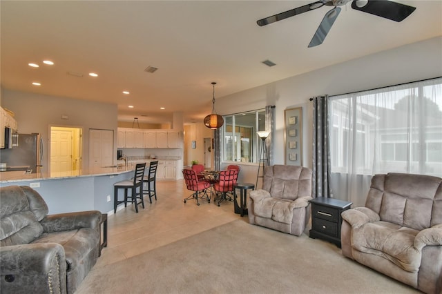 living room with ceiling fan and light tile patterned floors