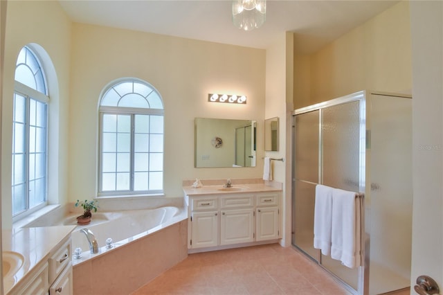 bathroom featuring tile patterned flooring, vanity, a wealth of natural light, and independent shower and bath