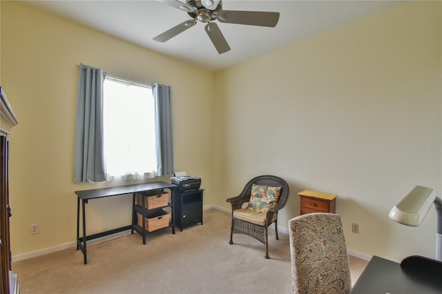 living area featuring light carpet and ceiling fan