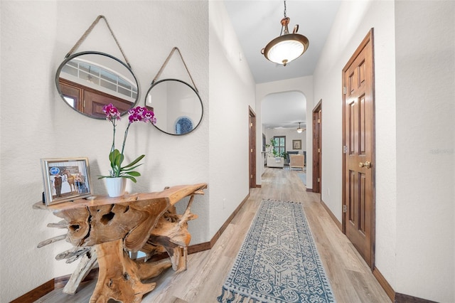 corridor with light hardwood / wood-style floors