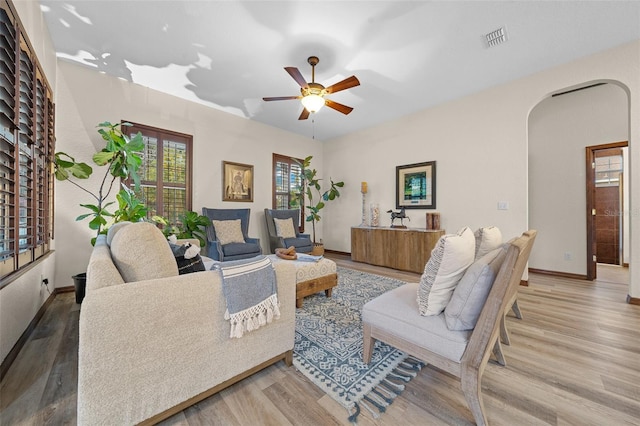 living room featuring hardwood / wood-style floors and ceiling fan