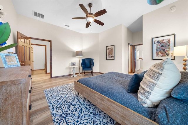 bedroom with connected bathroom, ceiling fan, and light hardwood / wood-style flooring