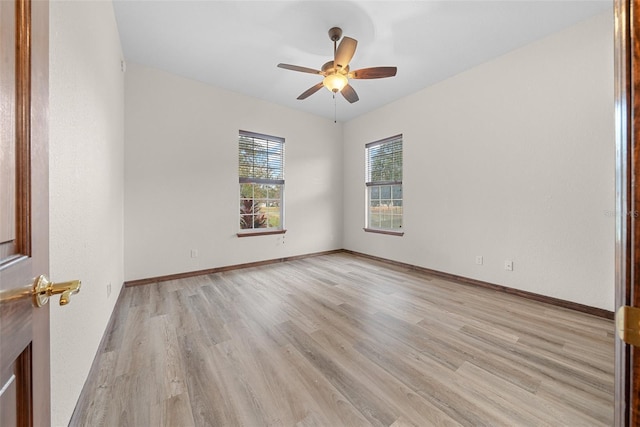 spare room with ceiling fan and light wood-type flooring