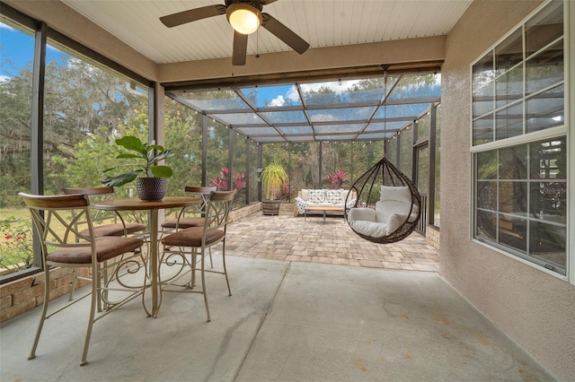 unfurnished sunroom with ceiling fan