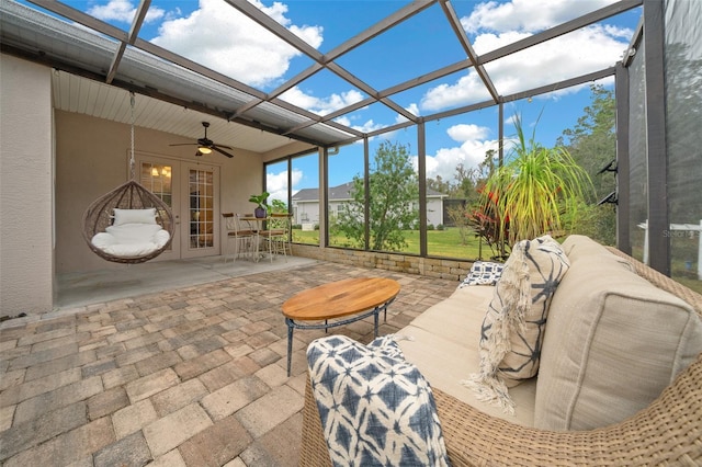 sunroom / solarium featuring ceiling fan