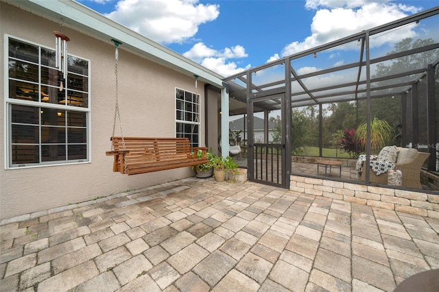 view of patio with glass enclosure