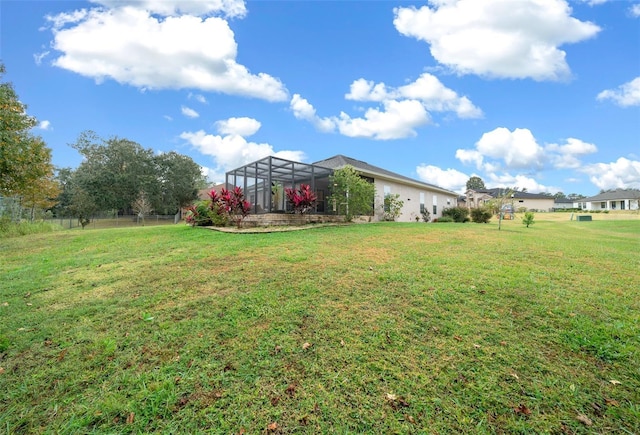 view of yard with glass enclosure