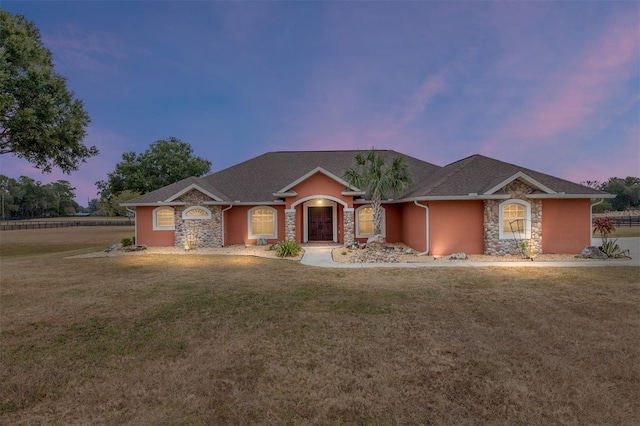 ranch-style home featuring a yard