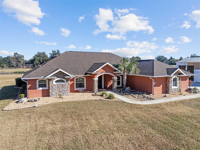 ranch-style home featuring a front lawn