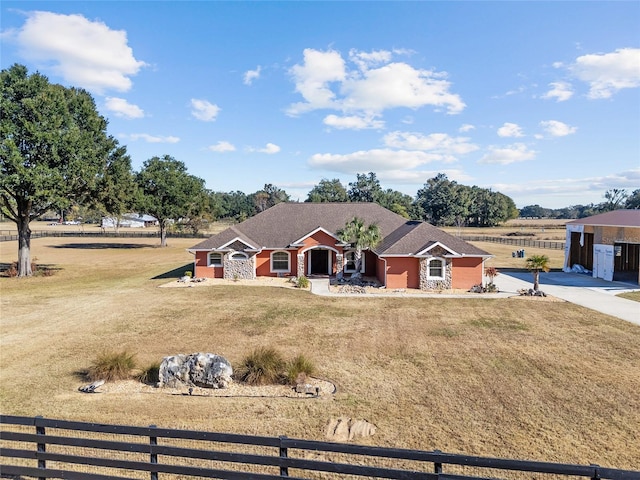 single story home featuring a rural view