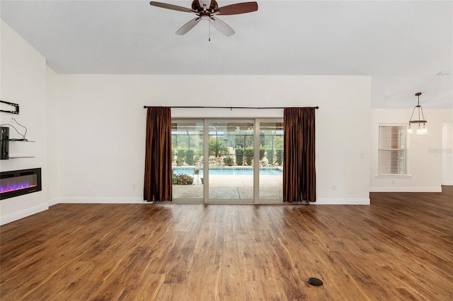 unfurnished living room with hardwood / wood-style floors and ceiling fan