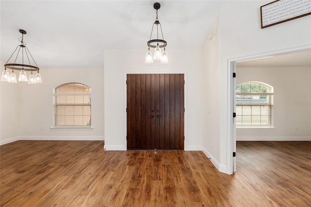 foyer featuring a notable chandelier and wood-type flooring