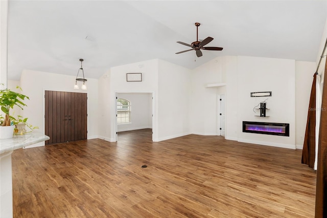 unfurnished living room featuring hardwood / wood-style flooring, ceiling fan, and high vaulted ceiling