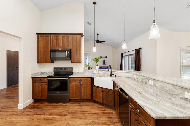 kitchen featuring stainless steel appliances, ceiling fan, sink, hardwood / wood-style flooring, and hanging light fixtures