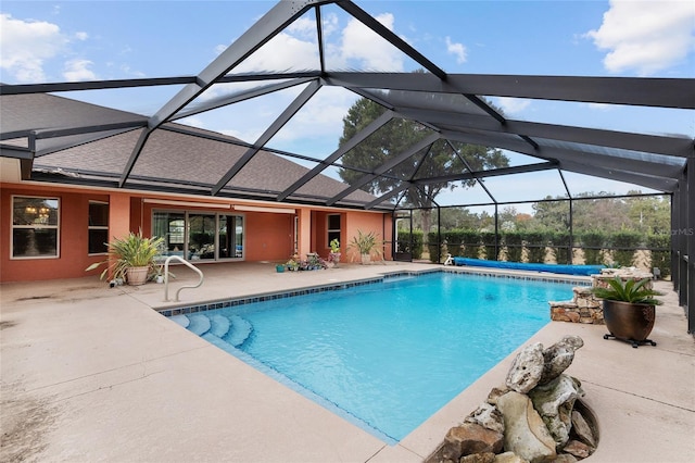 view of swimming pool featuring a lanai and a patio