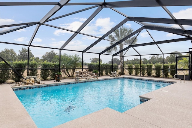 view of swimming pool with a lanai and a patio