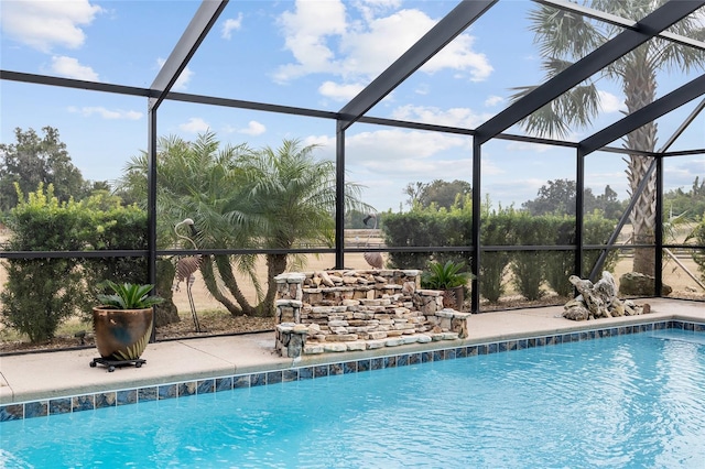 view of swimming pool with glass enclosure