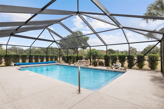 view of swimming pool featuring a patio and a lanai