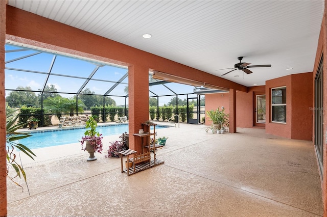 view of patio / terrace featuring glass enclosure and ceiling fan