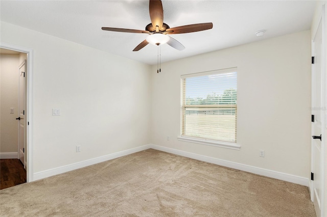 empty room featuring light carpet and ceiling fan