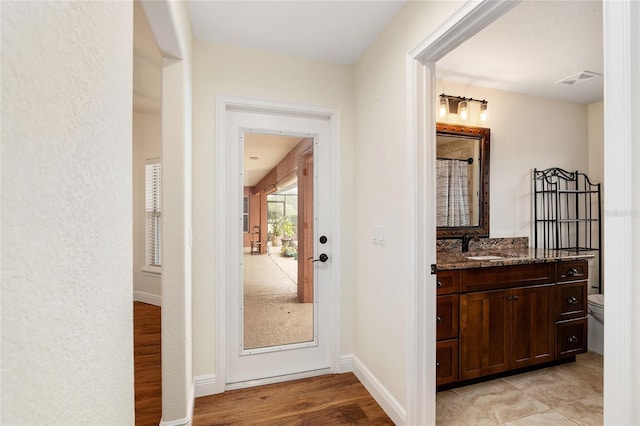 entryway featuring sink and light hardwood / wood-style floors