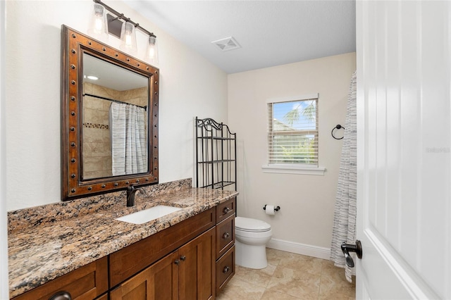 bathroom featuring tile patterned floors, a shower with curtain, vanity, and toilet