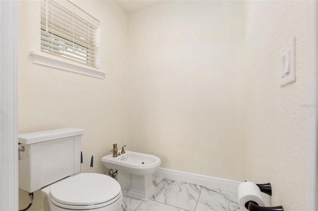 bathroom with toilet and a bidet