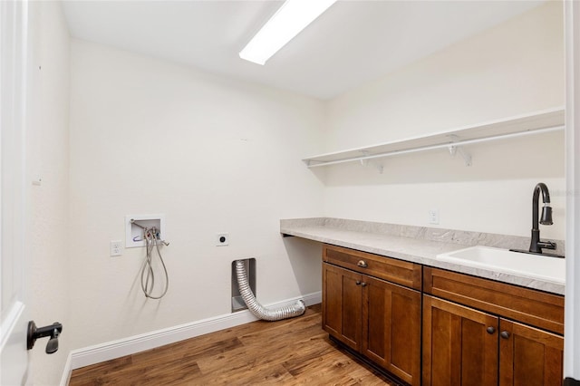 laundry area with sink, cabinets, electric dryer hookup, light hardwood / wood-style flooring, and hookup for a washing machine