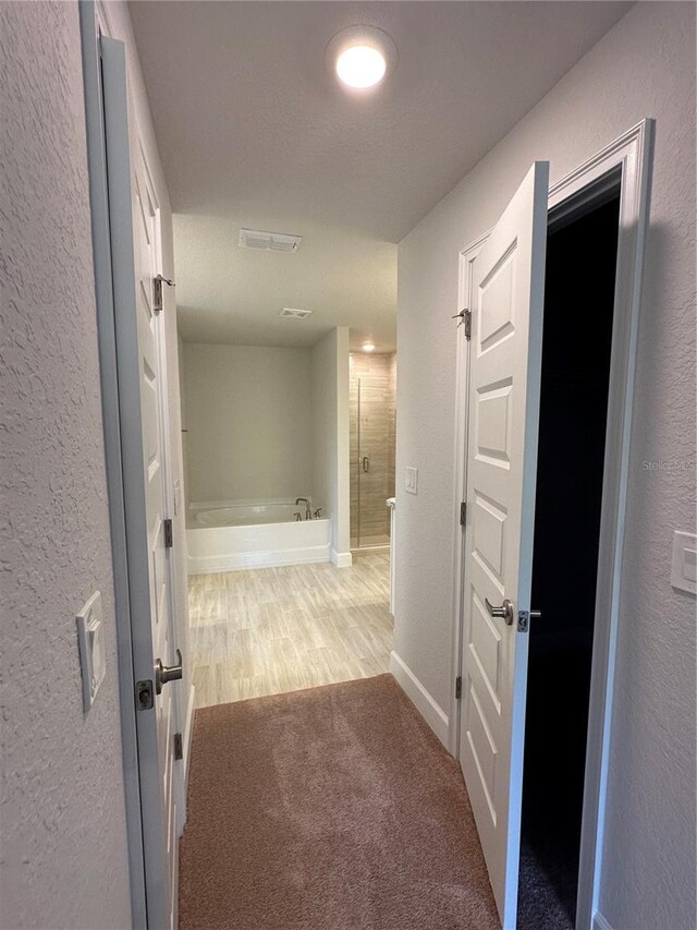 hallway featuring carpet flooring