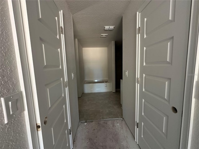 corridor with a textured ceiling