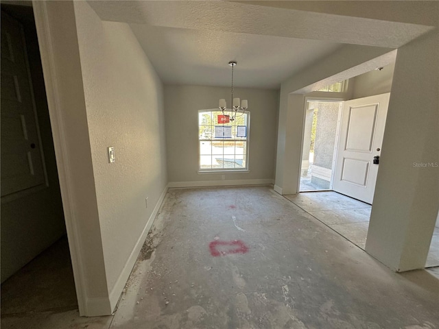 unfurnished dining area with a chandelier