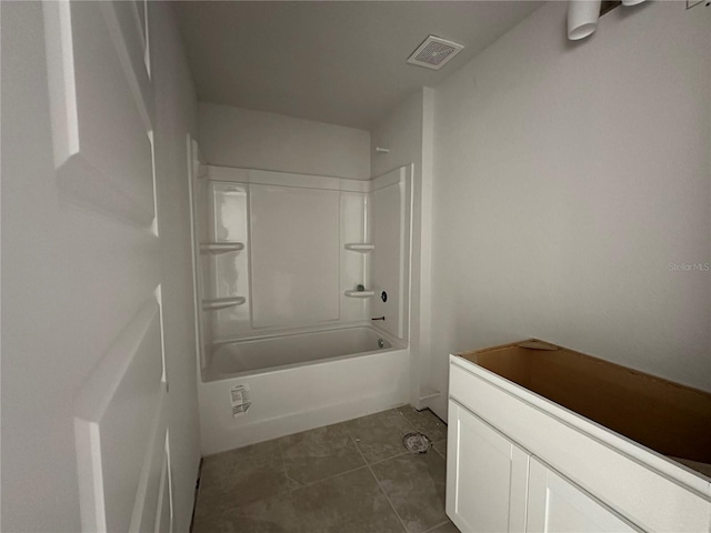 bathroom featuring tile patterned flooring and shower / bath combination