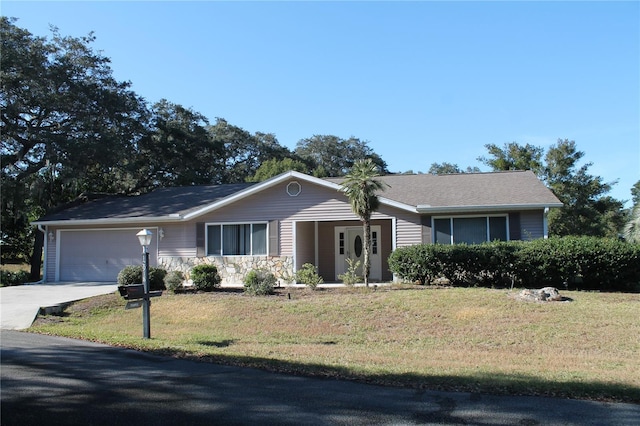 single story home with a garage and a front lawn