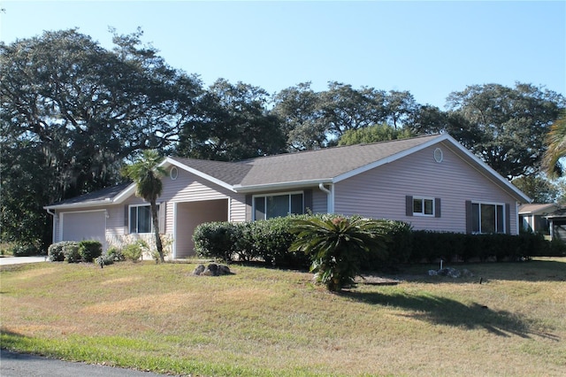 view of front of house featuring a front yard and a garage