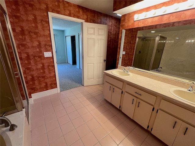 bathroom with tile patterned flooring, vanity, and an enclosed shower