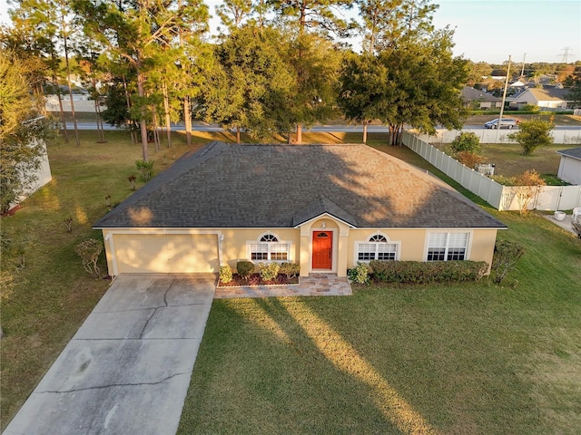 view of front facade with a garage and a front lawn