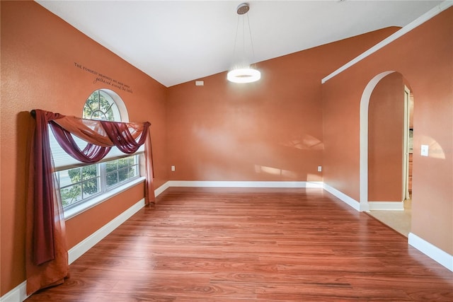 unfurnished dining area featuring hardwood / wood-style floors and lofted ceiling